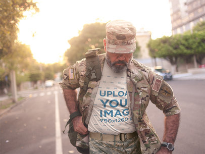 Veteran in Uniform Wearing a T-Shirt Mockup Walking Down the Street