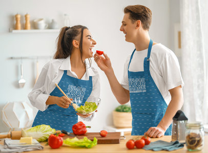 Apron Mockup of a Happy Couple Making a Salad and Having Fun