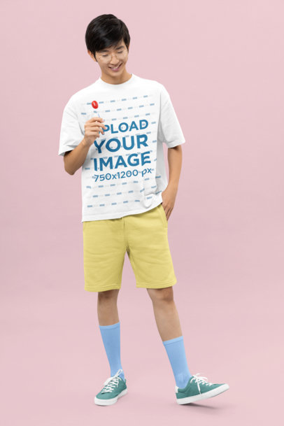 Oversized T-Shirt Mockup of a Happy Man With a Lollipop and a Kawaii Style m30689