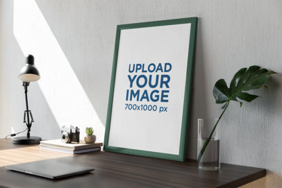 Mockup of a Photo Frame Leaning Against a Wall Near a Small Plant