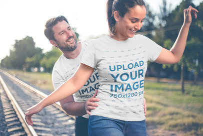 Couple Playing by the Tracks Wearing T-Shirts Mockup