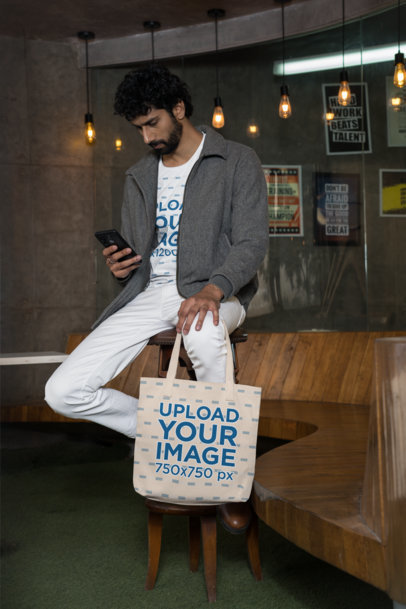 Gildan T-Shirt Mockup Featuring a Bearded Man Holding a Sublimated Tote Bag