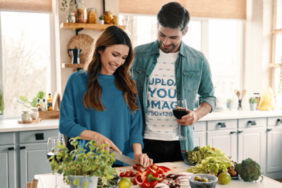 Round-Neck Tee Mockup of a Man Cooking With His Partner While Holding a Glass of Red Wine