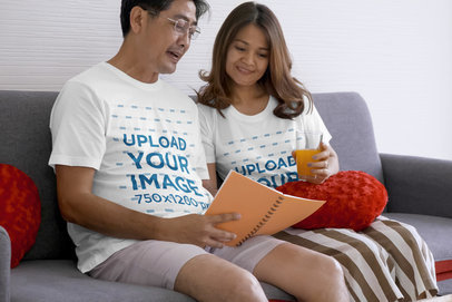 Round-Neck Tee Mockup of a Happy Couple Reading on Their Couch