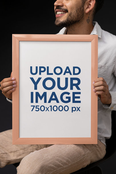 Mockup of a Happy Tattooed Man Holding an Art Print Frame