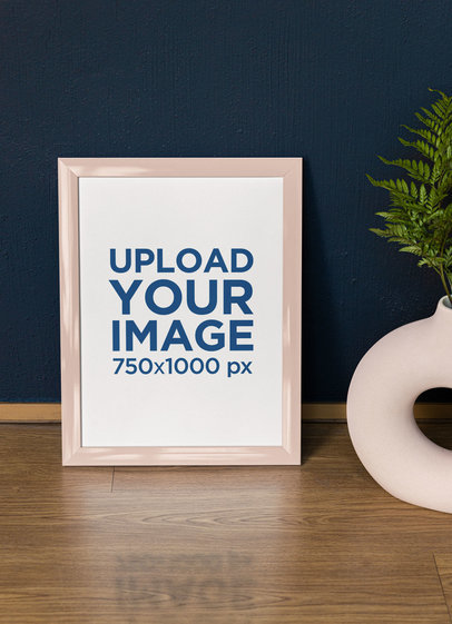 Mockup of a Vertical Art Print Standing on a Wooden Surface m31599