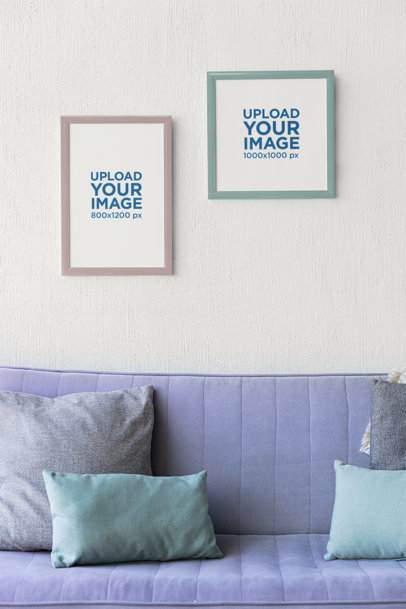Mockup of Two Art Prints Hanging on a Wall Featuring a Couch