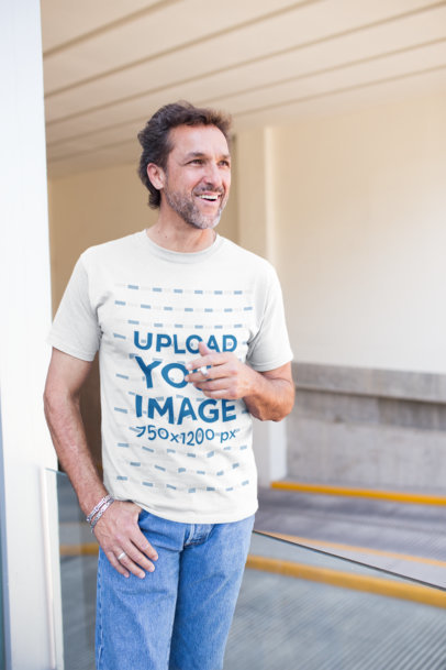 Middle-Age Man Wearing a T-Shirt Mockup While Smoking Outside the Parking Lot
