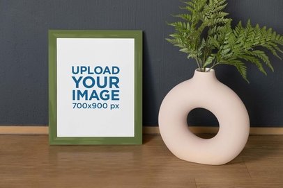 Mockup of a Vertical Art Print Placed Next to a Contemporary Flower Vase