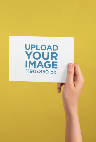 Horizontal Postcard Mockup Being Held Against a Color Background