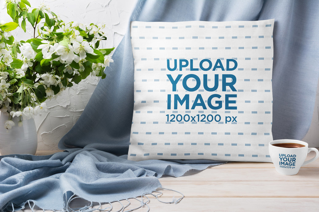 Mockup of a Square Pillow Placed Next to a Coffee Mug