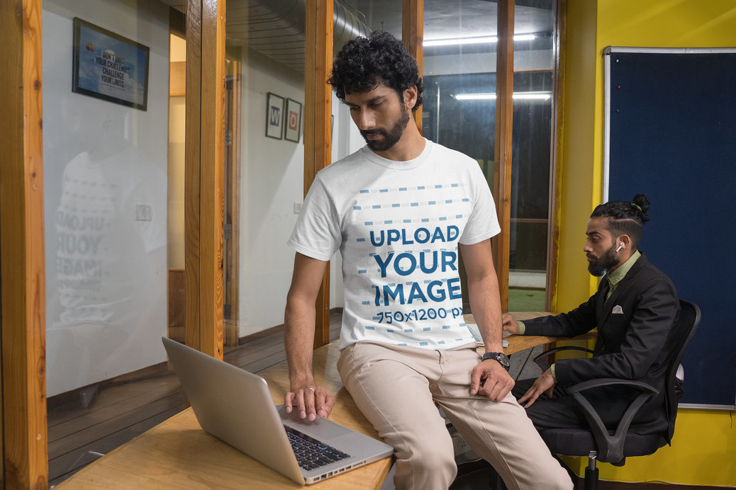 Round-Neck Gildan Tee Mockup of a Bearded Man Working on His Laptop