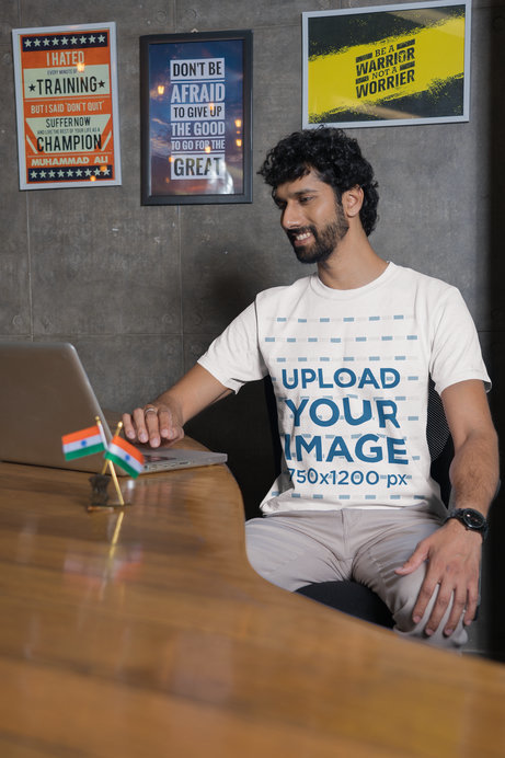 Round-Neck Gildan Tee Mockup of a Bearded Man Using His Laptop