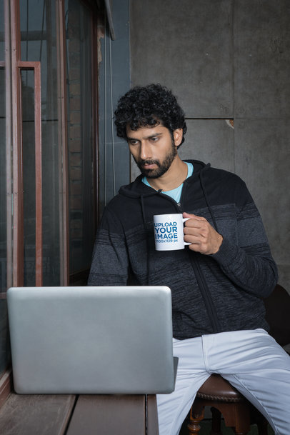 11 oz Coffee Mug Mockup of a Bearded Man Working on His Laptop