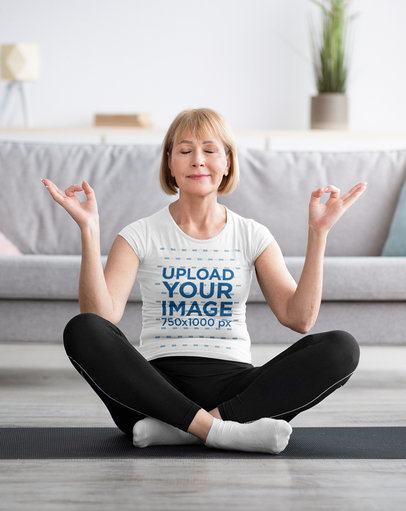 T-Shirt Mockup Featuring a Senior Woman Practicing Yoga in the Living Room m10041 r-el2