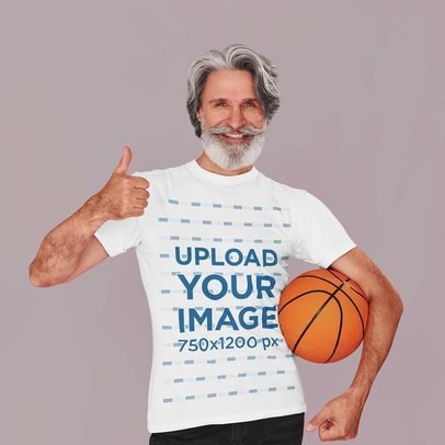 T-Shirt Mockup Featuring a Senior Man Holding a Basketball and Giving a Thumb Up m24444 r-el2