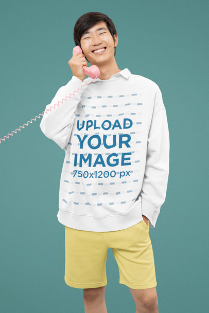 Oversized Sweatshirt Mockup of a Smiling Man Using a Pink Corded Phone m30717
