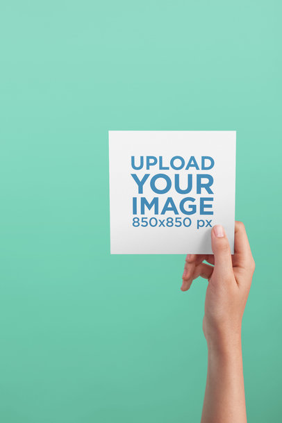 Post Card Mockup Being Held Against a Solid Color Background