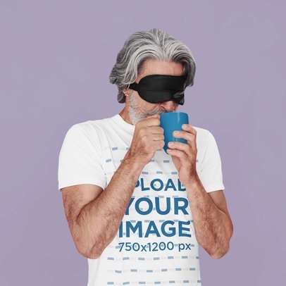 T-Shirt Mockup of a Senior Man With a Sleep Mask Drinking Coffee