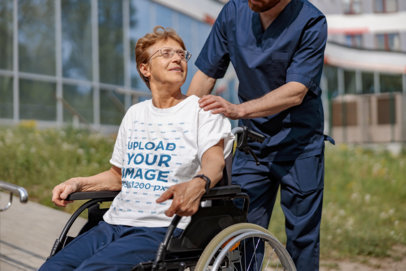 Round-Neck T-Shirt Mockup Featuring a Senior Man on a Wheelchair
