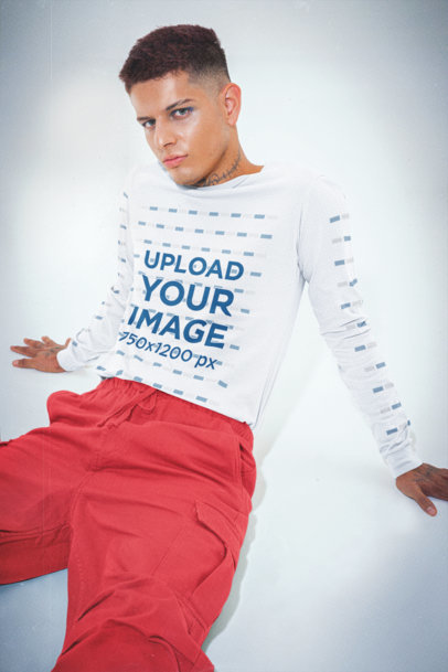 Long-Sleeve Tee Mockup of a Serious Tattooed Man Sitting on the Floor