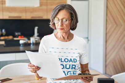 Round-Neck Tee Mockup of an Elderly Woman Reading Papers m19472 r-el2
