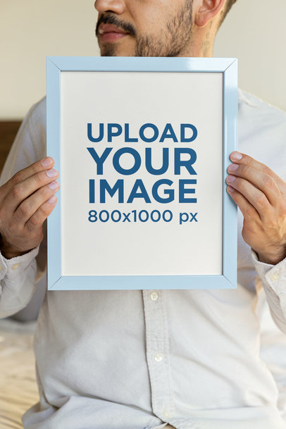 Mockup of a Bearded Cropped Face Man Holding an Art Print