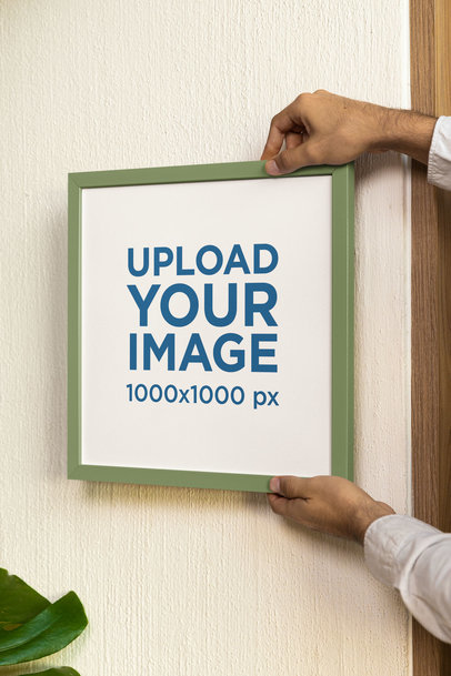 Mockup of a Man Holding a Squared Art Print