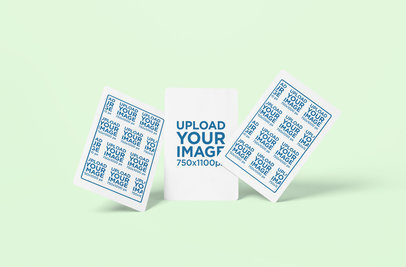 Mockup of Three Playing Cards Standing on a Solid Surface