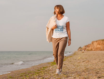 V-Neck Tee Mockup of an Elderly Woman Walking on the Beach m28579 r-el2