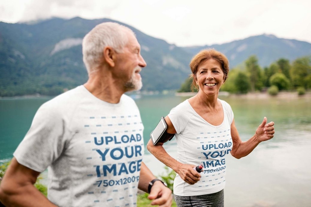 T-Shirt Mockup Featuring a Senior Couple Running by a Lake