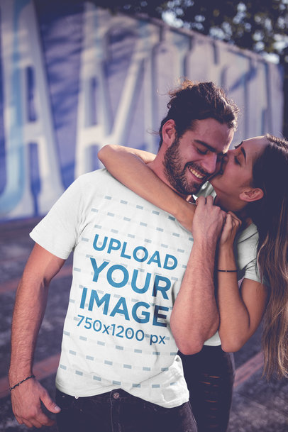 T-Shirt Mockup Featuring a Young Couple Hugging in an Urban Setting