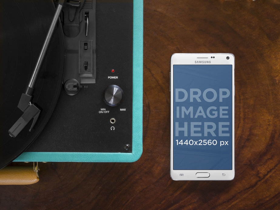 Mockup of a Samsung Phone Placed Next to a Turntable