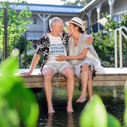 T-Shirt Mockup of a Happy Senior Man Hugging His Partner by the Lake