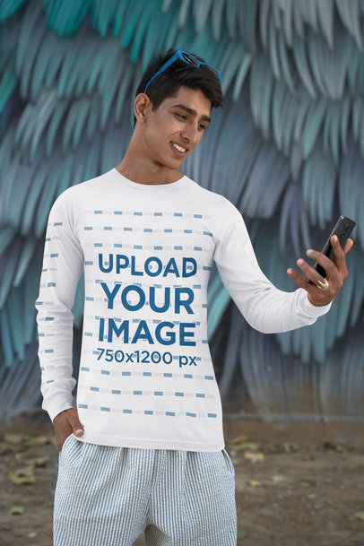 Bella Canvas Long Sleeve Tee Mockup of a Happy Man Checking Out His Phone