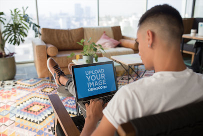 Mockup of a Man Working with his MacBook at Home
