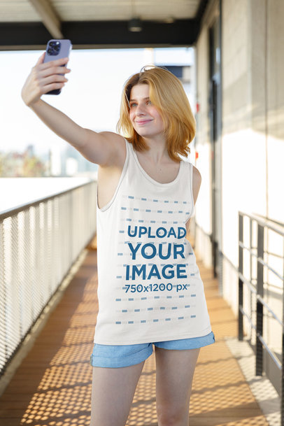 Tank Top Mockup Featuring a Woman Taking a Selfie with Her Smartphone