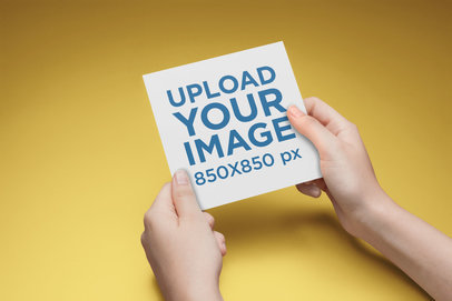 Square Postcard Mockup Being Held with Both Hands