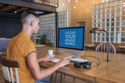 Man Working with an iMac Mockup at a Modern Place