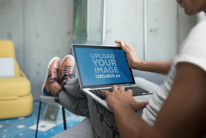 Mockup of a Man Working in his MacBook Pro 