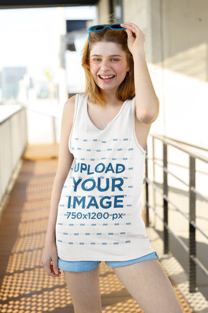 Mockup of a Smiling Woman Wearing a Loose Tank Top