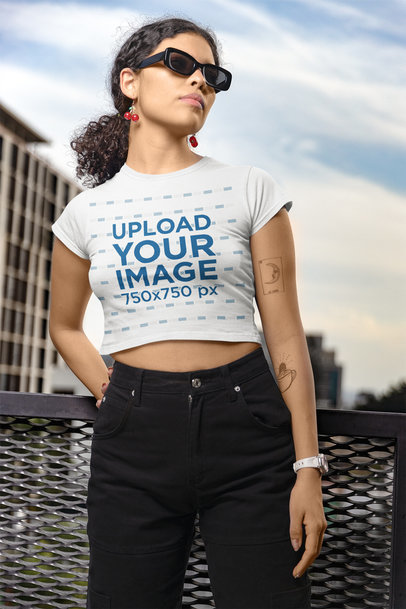 Crop Top Mockup Featuring a Tattooed Woman With a Curly Ponytail Hairstyle 