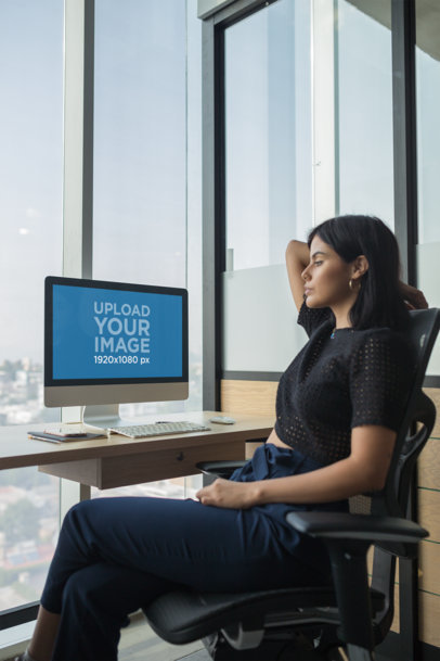 Woman Watching her iMac Mockup at the Office