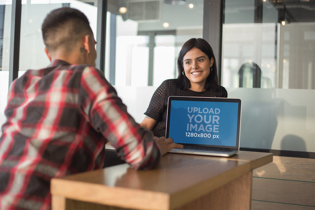 Coworkers Talking while Working in a MacBook Mockup