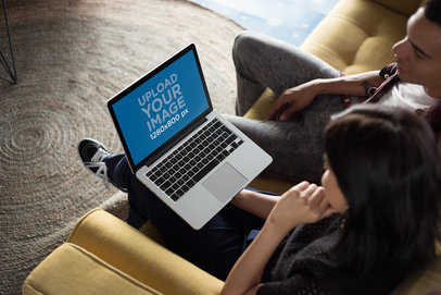 Coworkers Working on a MacBook Mockup while Talking About It a20769
