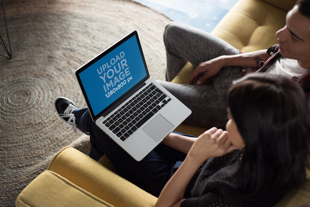 Coworkers Working on a MacBook Mockup while Talking About It