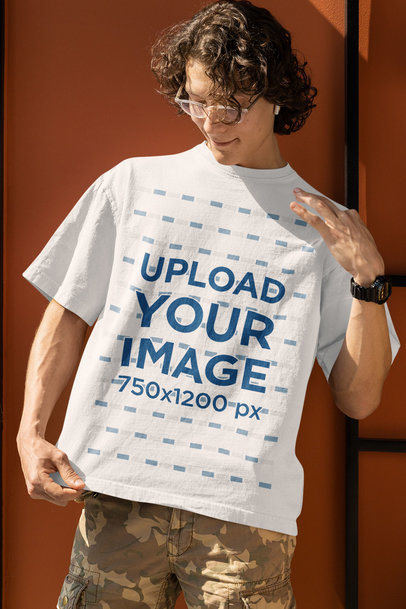 Oversized T-Shirt Mockup Featuring a Smiling Man With Curly Long Hair