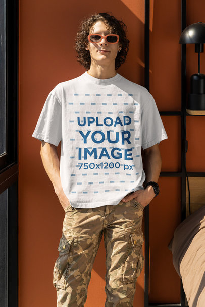 Round-Neck T-Shirt Mockup Featuring a Smiling Man Posing in His Bedroom