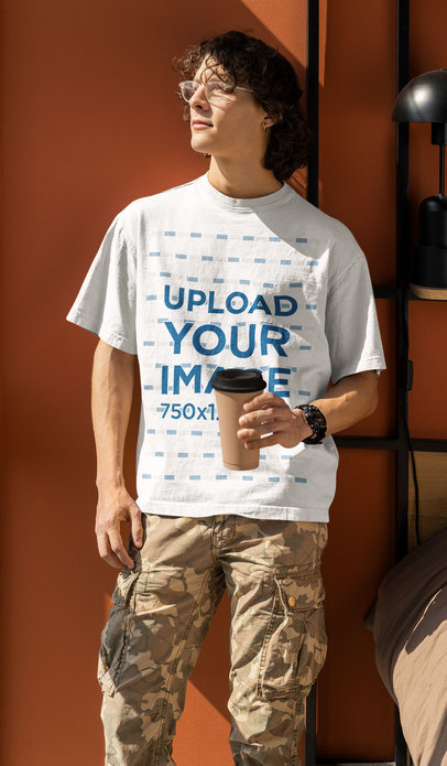 Oversized T-Shirt Mockup Featuring a Man Holding a Coffee