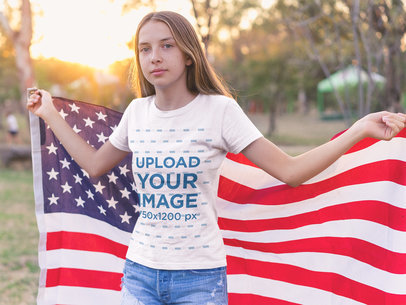 Teen White Girl Wearing a T-Shirt Mockup while Holding the American Flag
